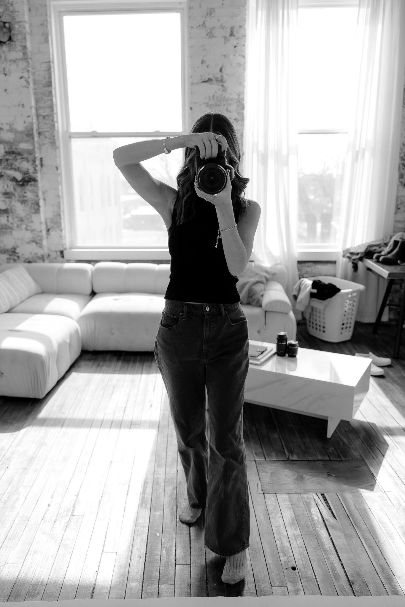 Black and white photo sequence in bright room with hardwood floors and white walls.