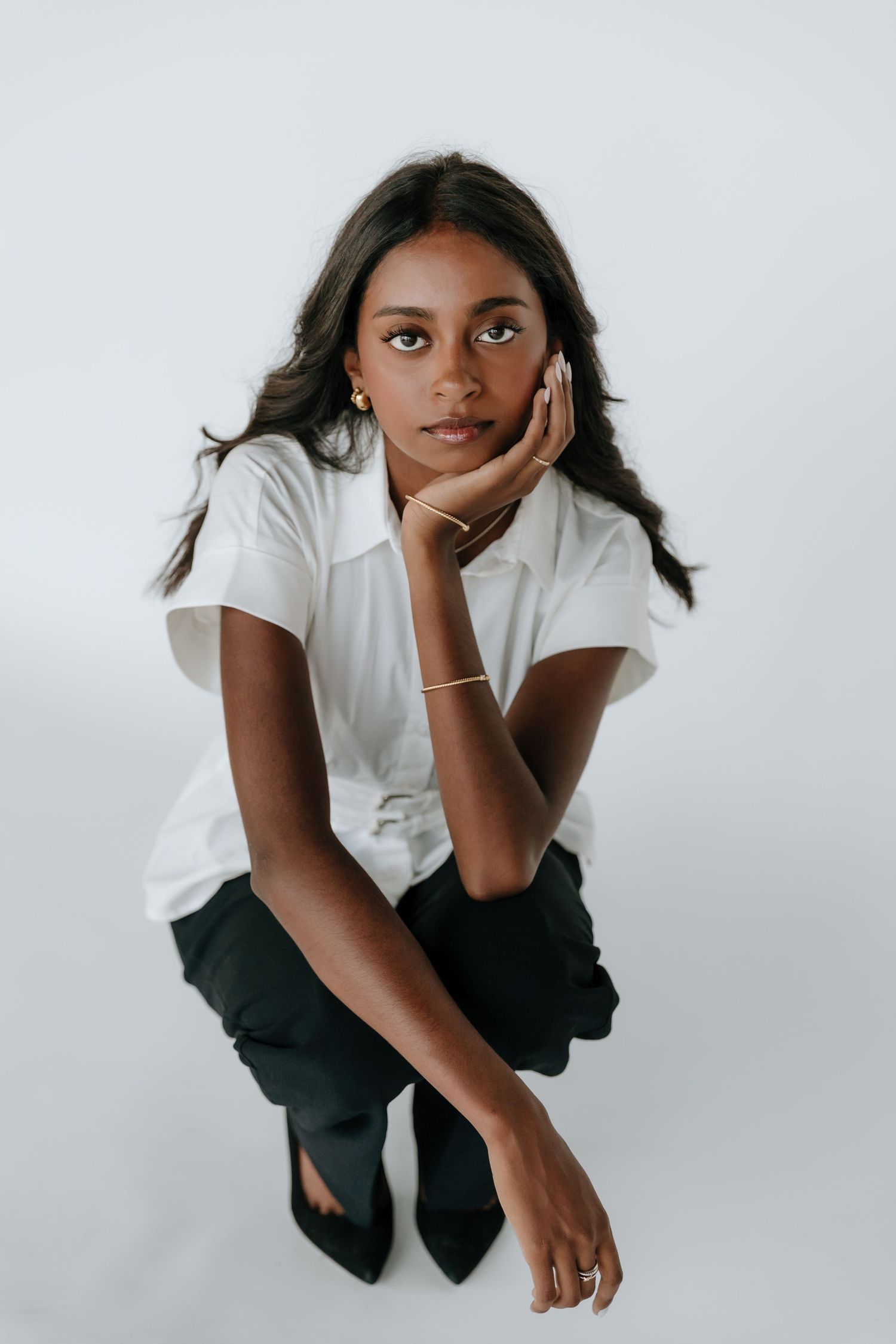 Studio photoshoot showcasing casual poses against a white background in monochromatic attire.