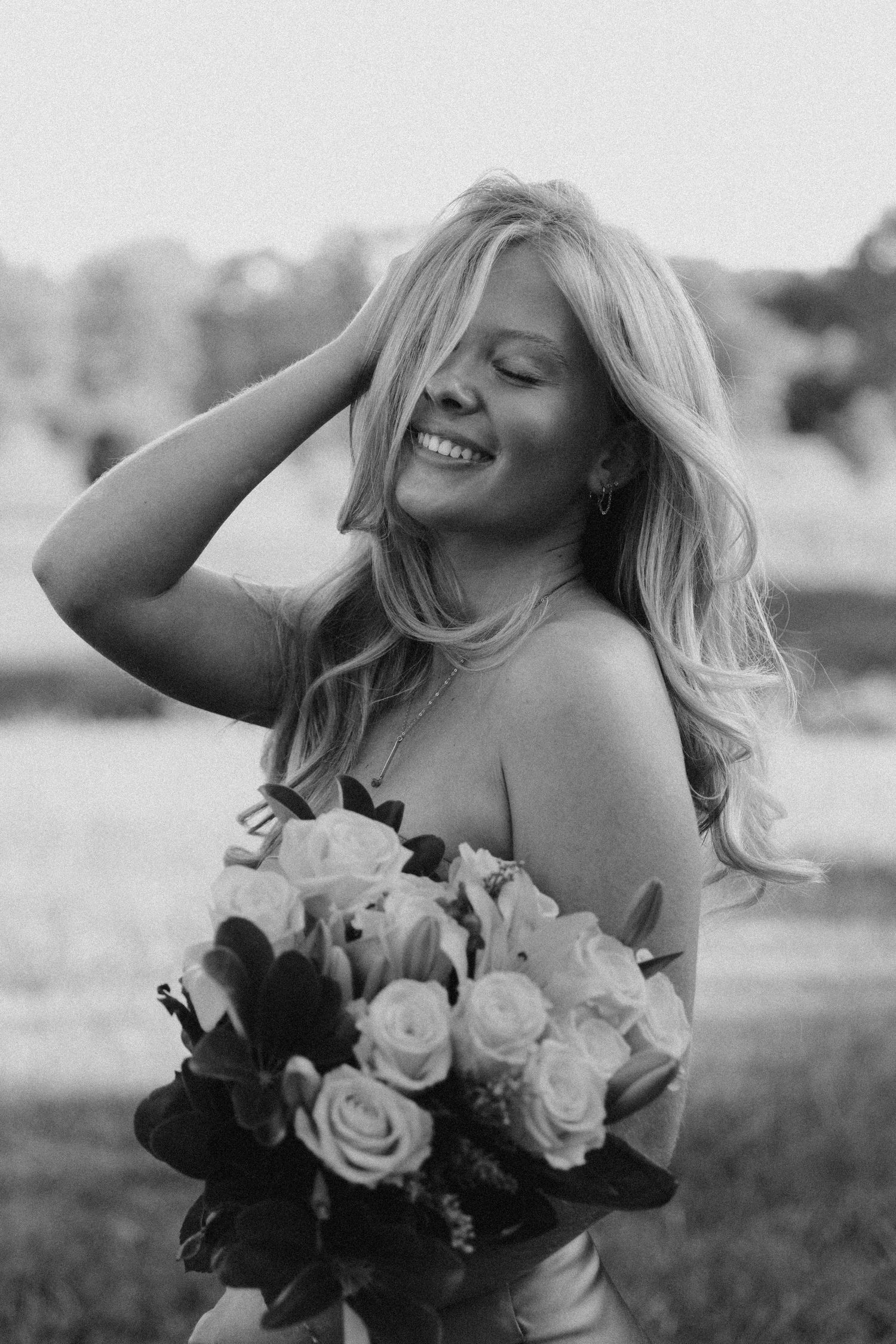 Black and white photo series of a person holding a bouquet of roses while posing expressively outdoors.