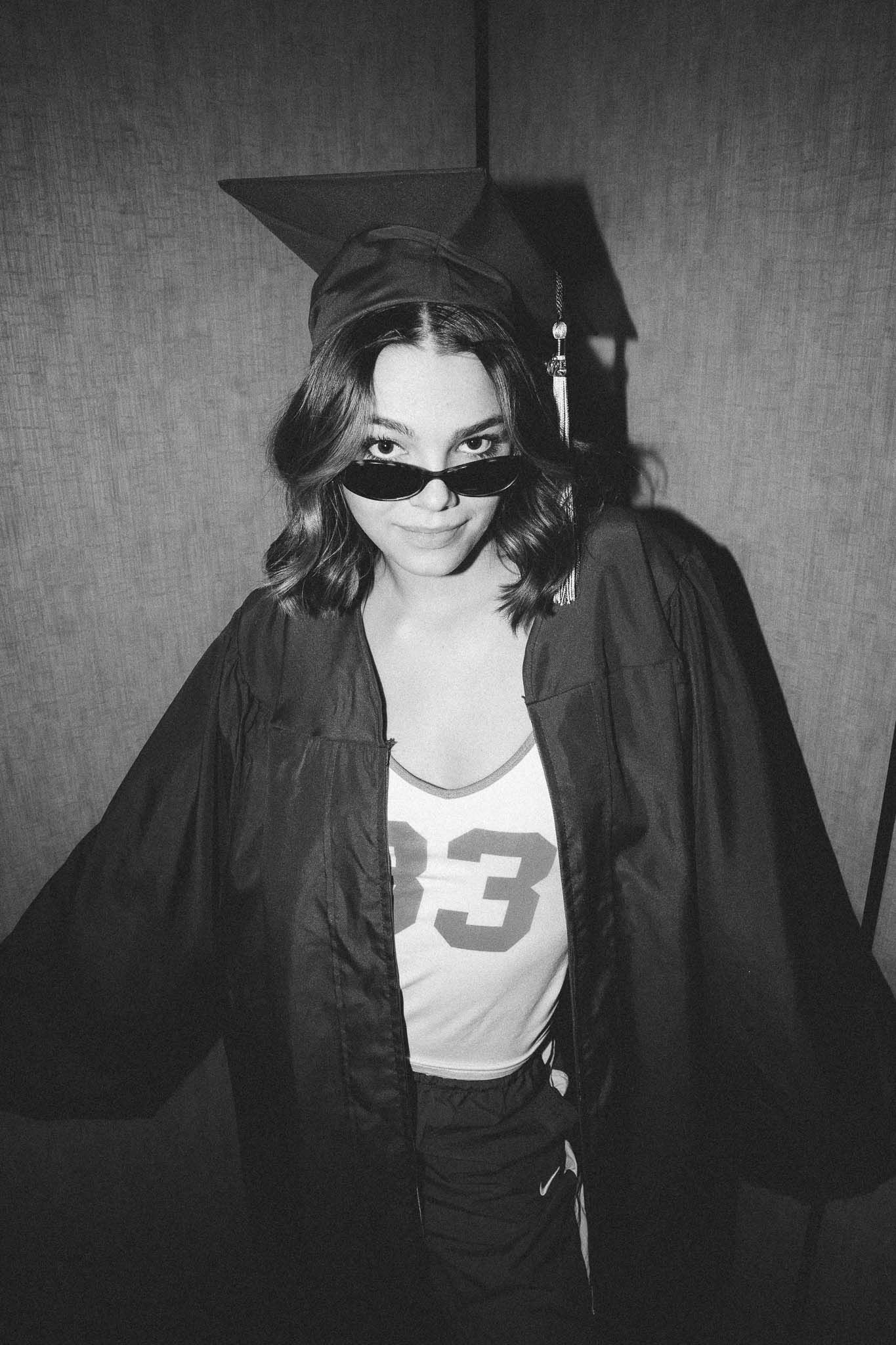A series of black and white photographs showing a figure in graduation attire and cap against a textured background.