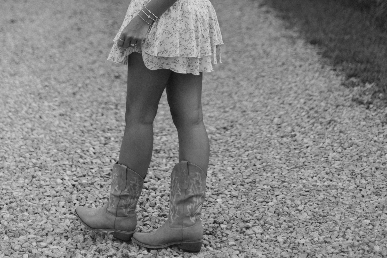 Black and white detail shots of lace dress and boots on gravel ground.
