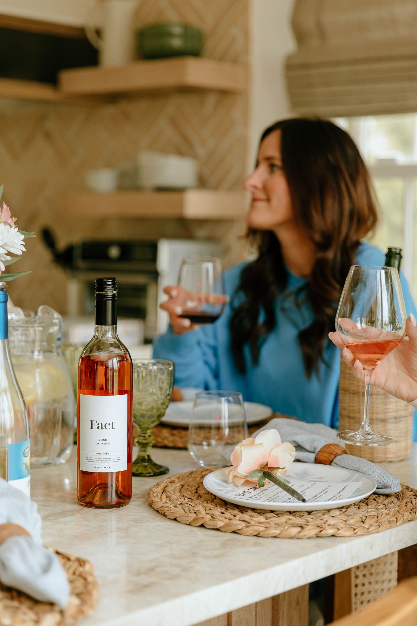 Table setting with wine bottles and glassware for an intimate gathering.