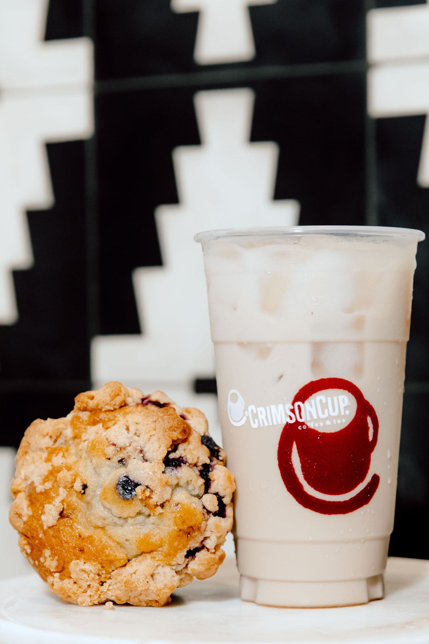Fresh baked pastries displayed alongside Grindstone Coffee branded cups.