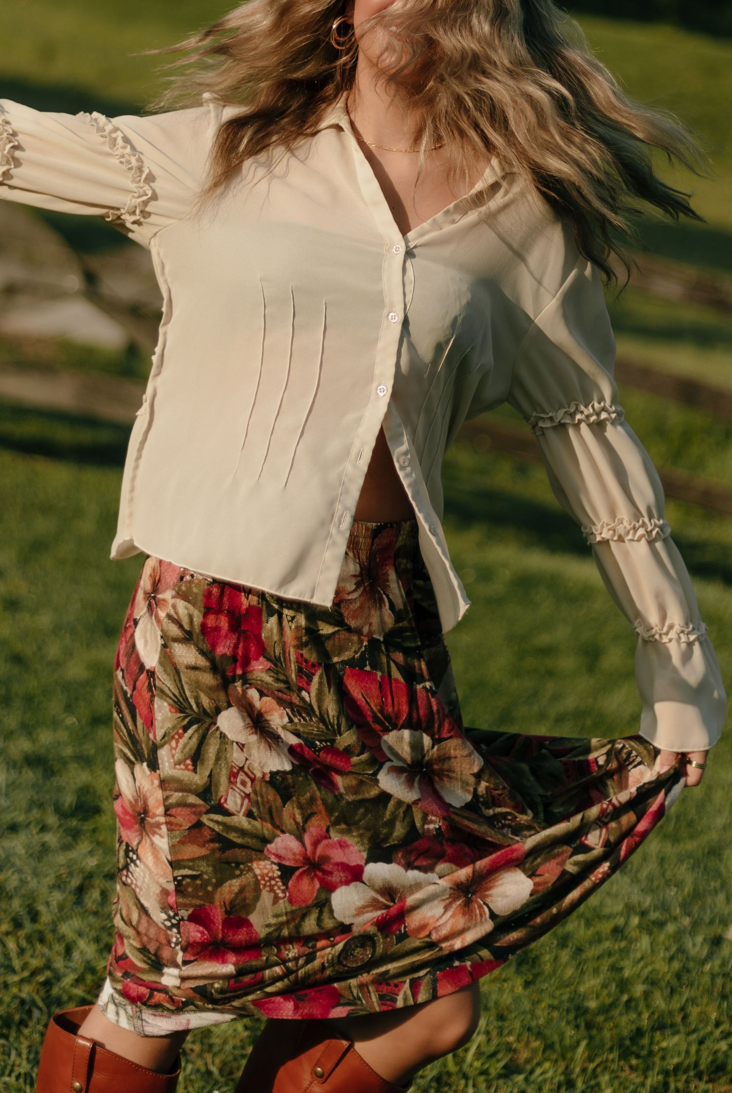 Fashion shots featuring a flowing floral skirt and cream blouse in natural outdoor lighting.