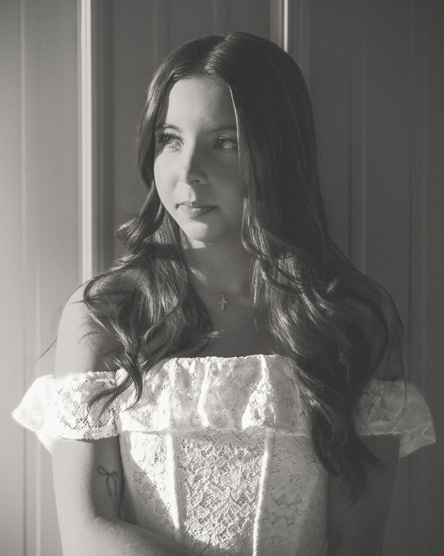 Black and white portrait series featuring soft lighting and delicate lace details.