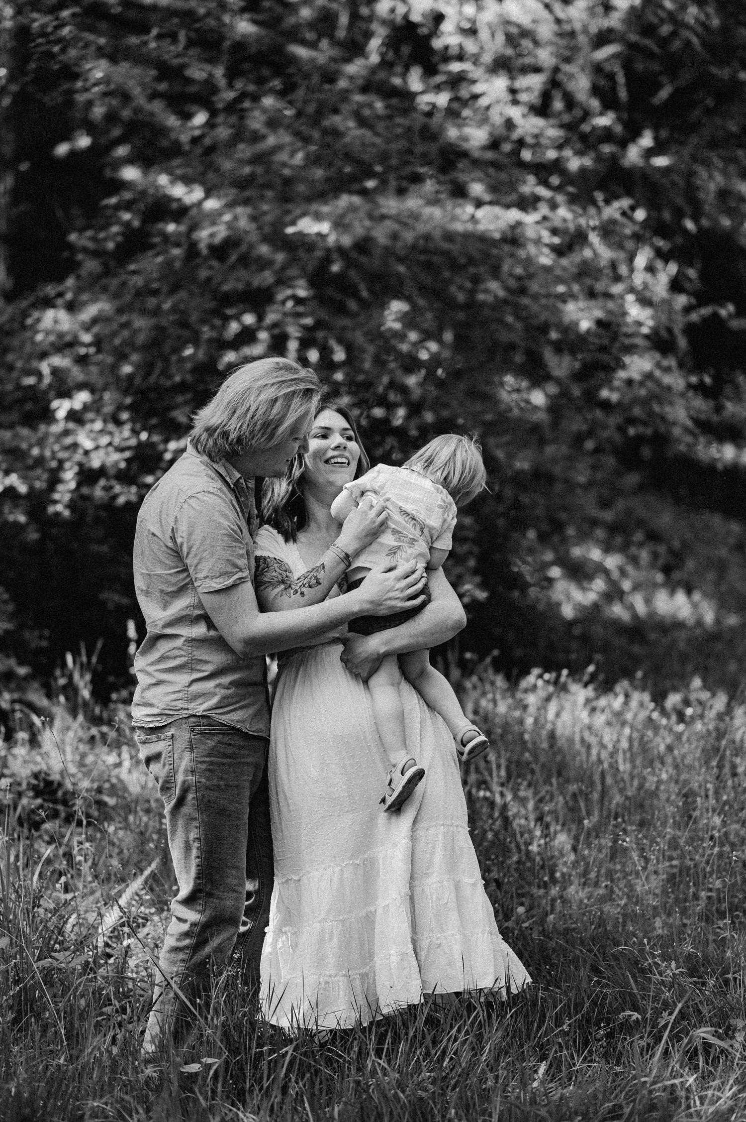 A loving family playing with their child at the park