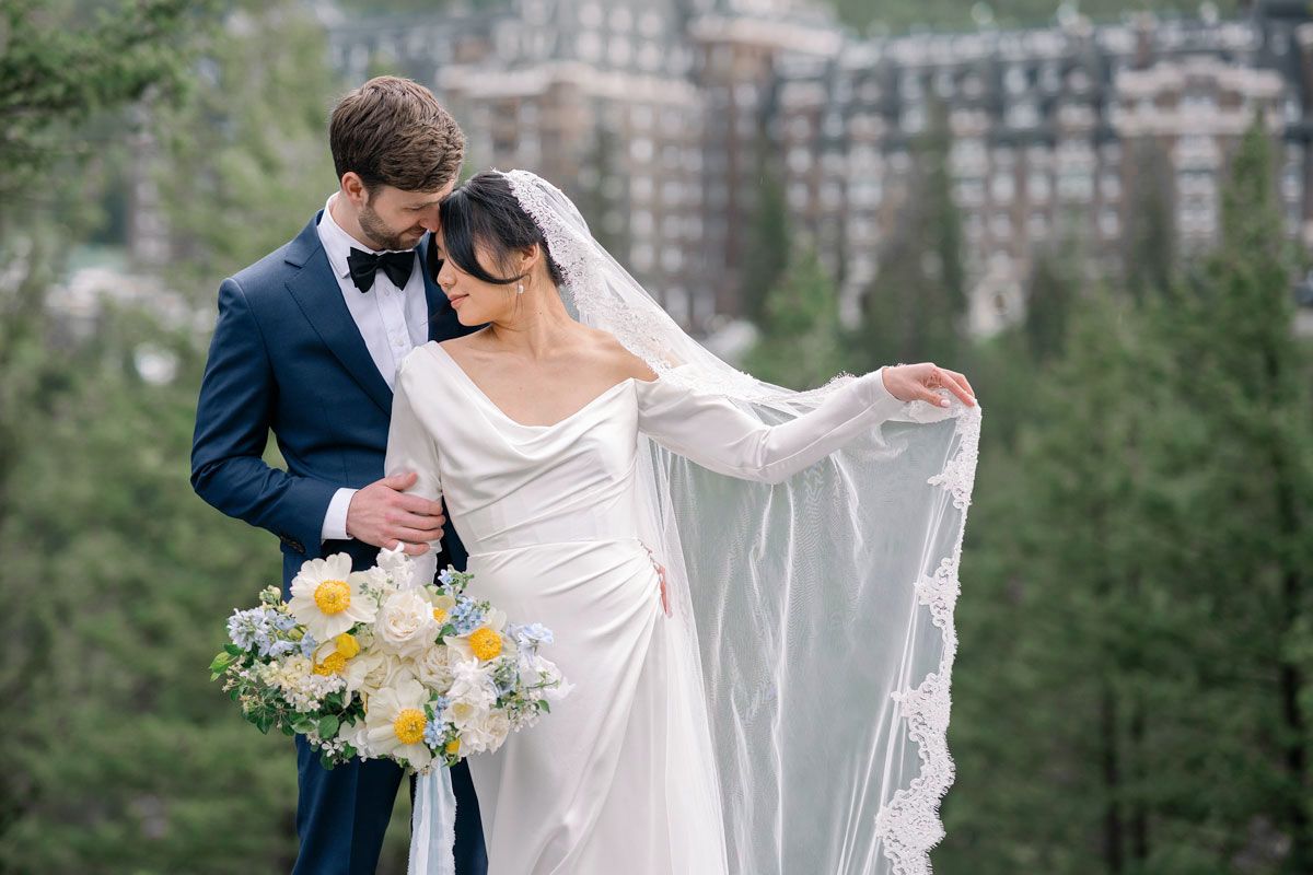 Bride and groom posing in front of a Latvian castle, romantic wedding portrait with historic backdrop