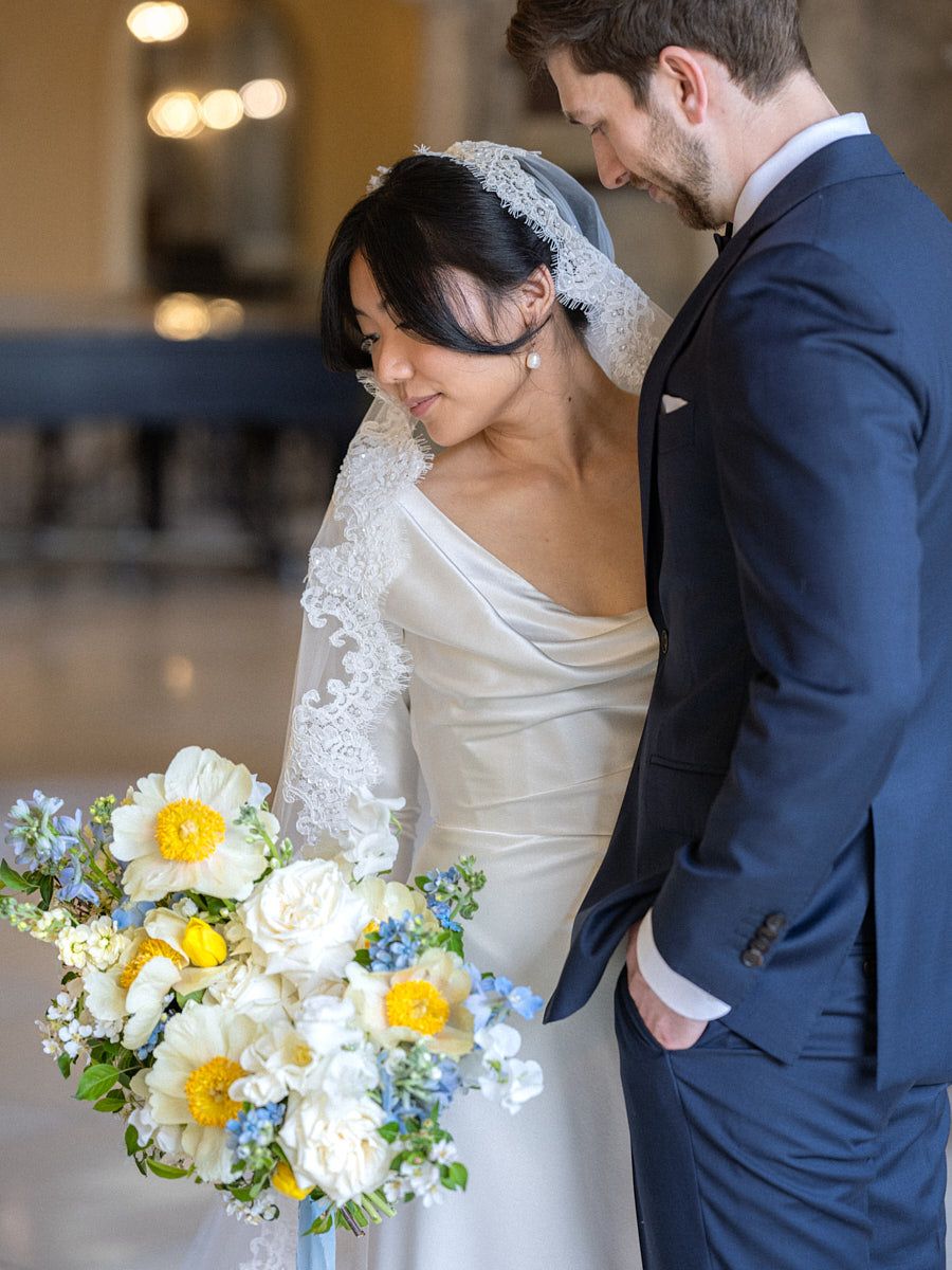 Elegant castle wedding portrait focusing on bride and groom’s expressions and details