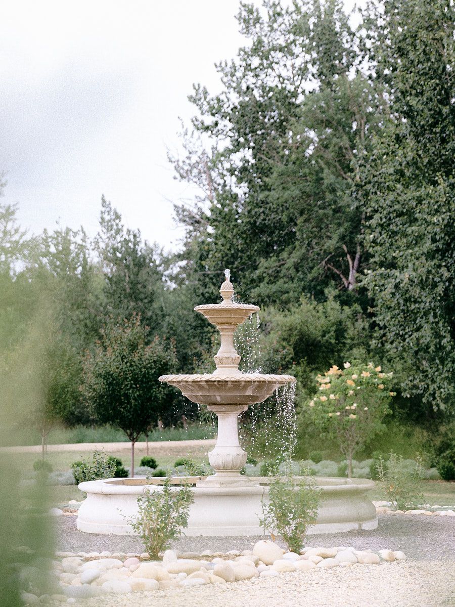 Elegant stone fountain at a Latvian wedding venue, a stunning backdrop for wedding photos.