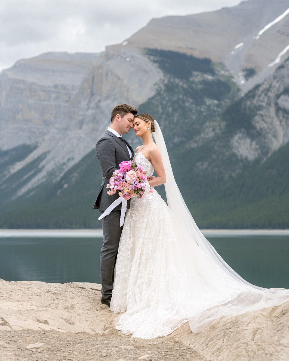 Romantic bride and groom portrait by a mountain lake, perfect for European weddings