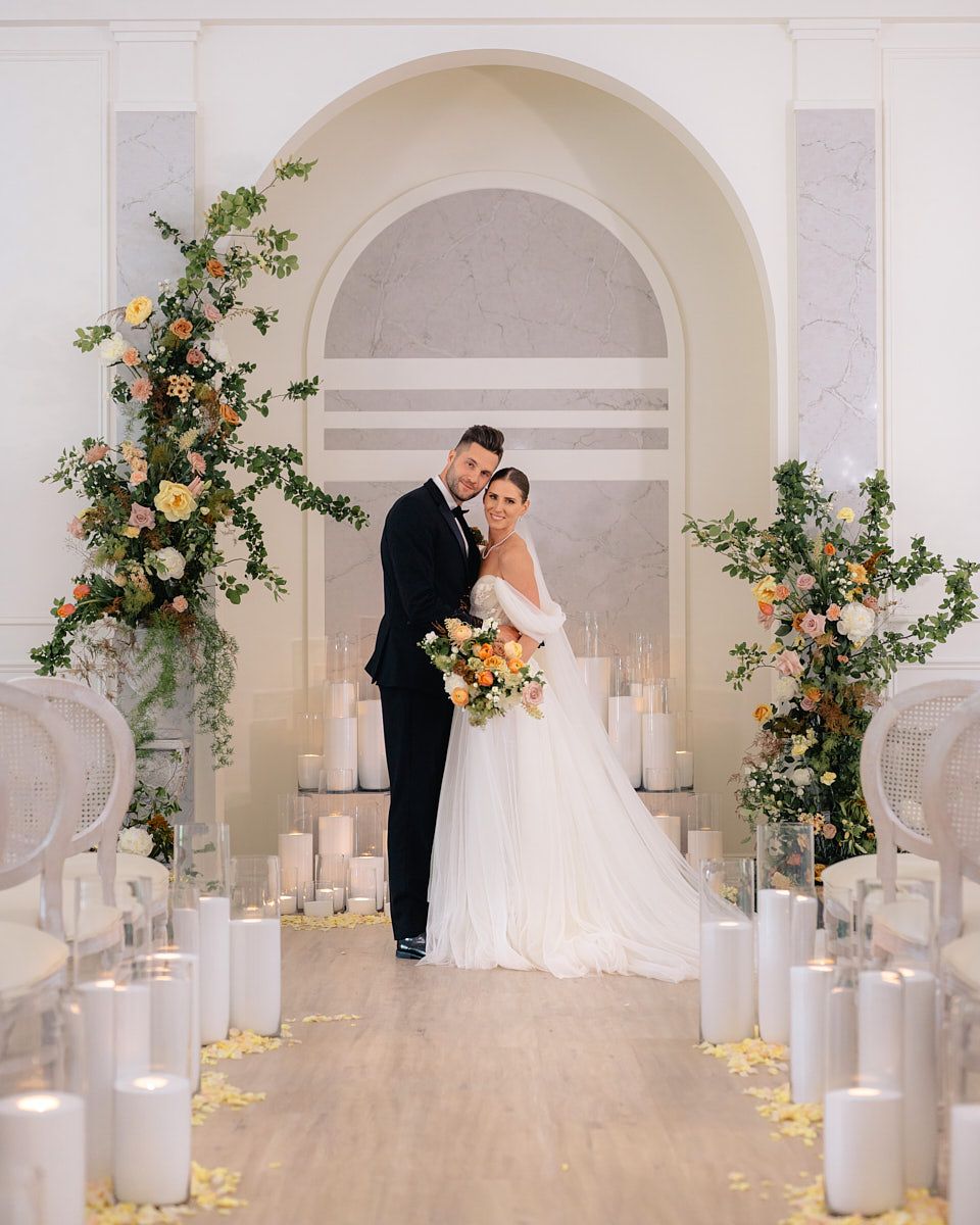 Romantic Riga wedding ceremony with couple framed by arch and warm candlelight