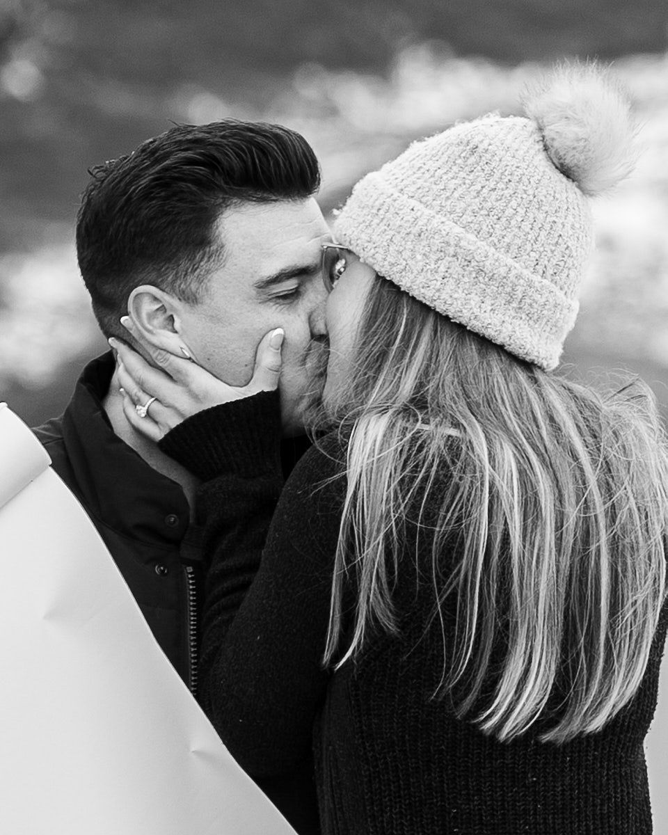 Proposal with “Will you marry me” scroll in scenic mountain engagement session in Europe