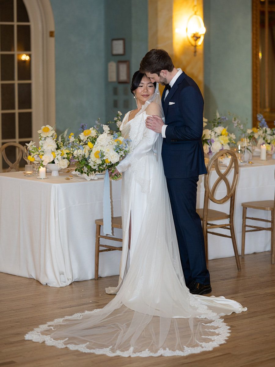 Bride and groom enjoying romantic moments in a majestic castle hall, perfect for wedding inspiration