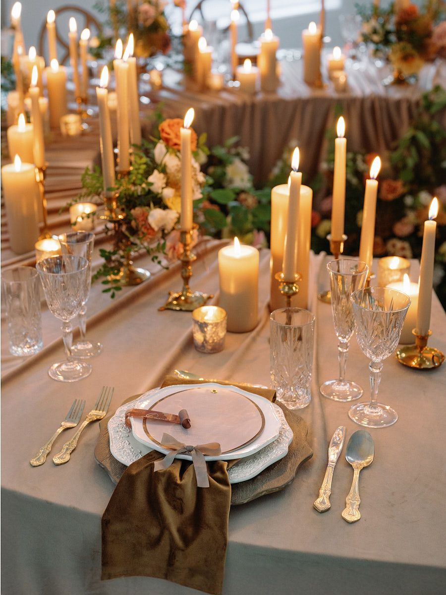 Wedding table setting with plate and candles, elegant Riga wedding reception detail shot