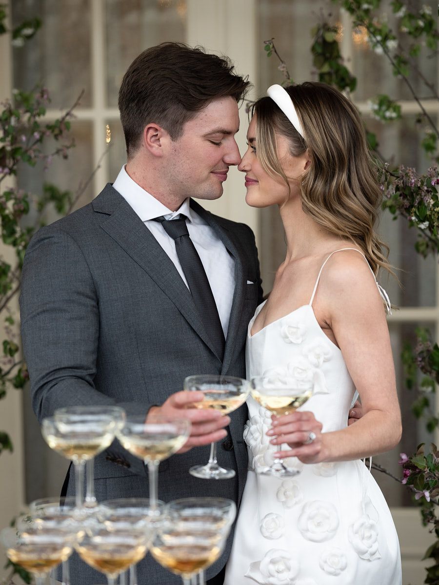 Newlyweds celebrating with champagne tower at Riga reception