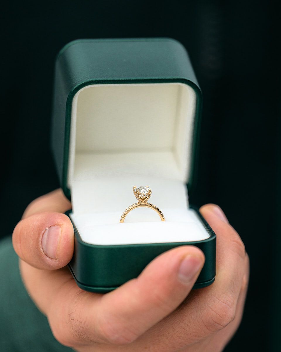 Diamond engagement ring in green velvet box, luxury proposal detail in Riga