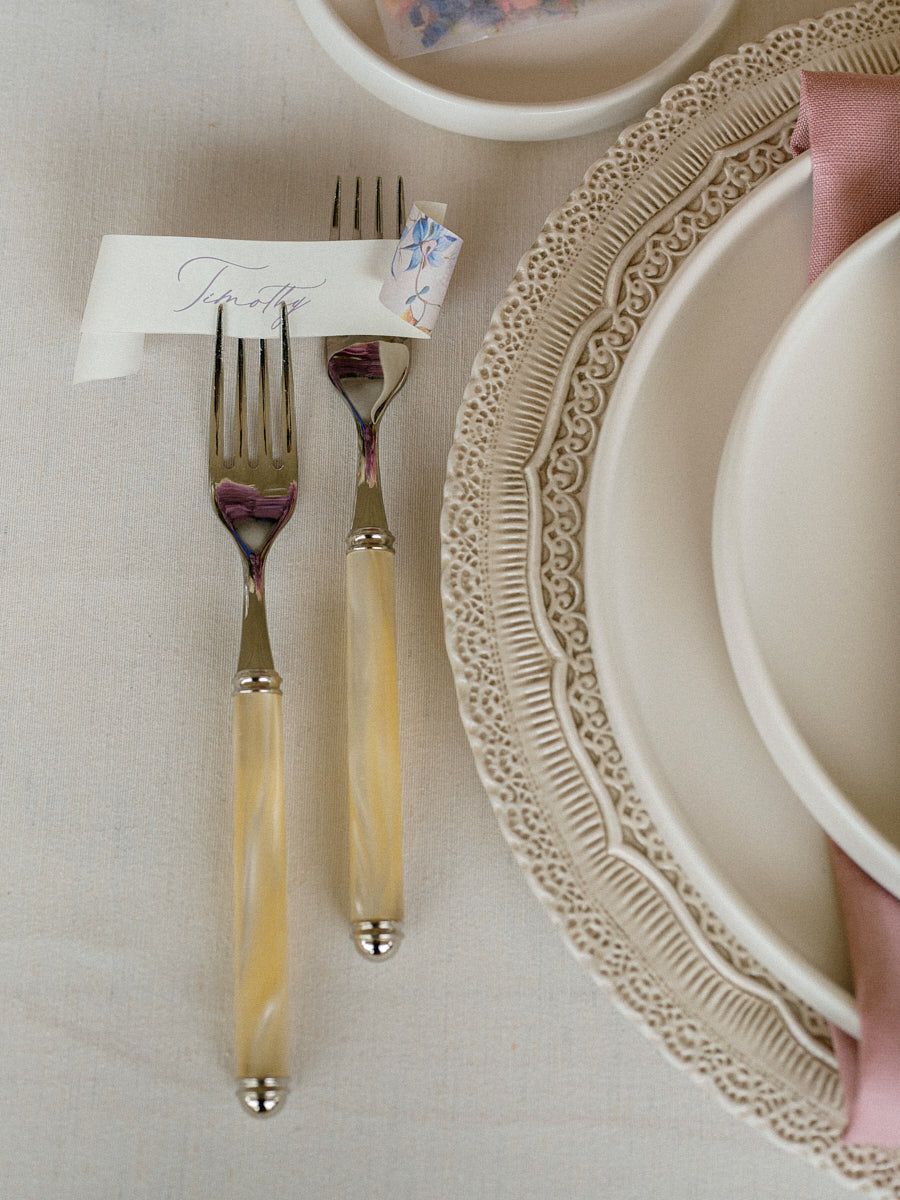 Elegant pastel wedding table setting with florals, plates, and glassware, perfect for Riga weddings