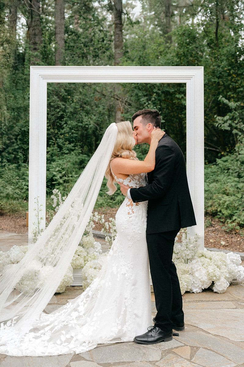 A newlywed couple shares their first kiss as husband and wife during their Riga wedding ceremony.