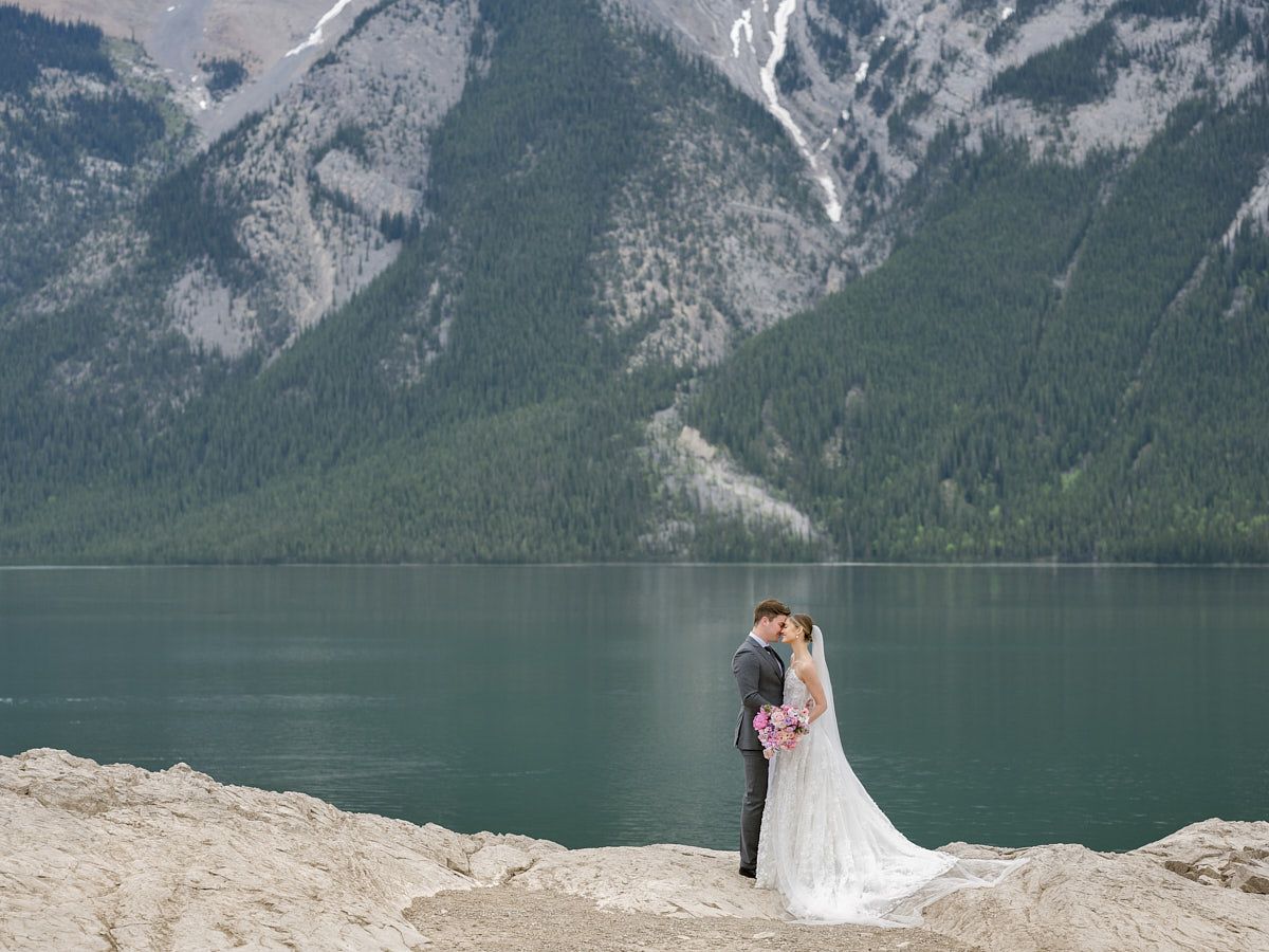 Romantic European wedding couple by a mountain lake, captured in natural light near Riga