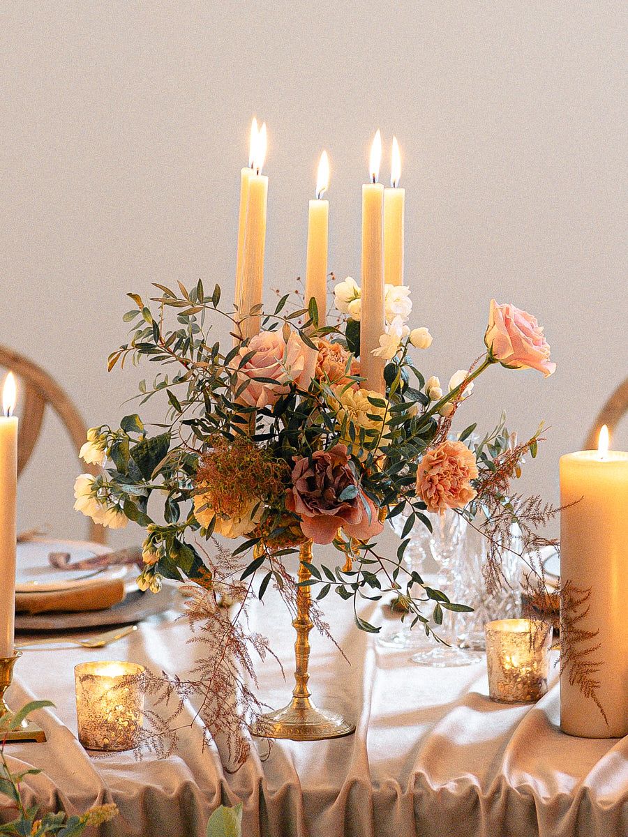 Elegant candle holder with lit candles on Riga wedding reception table, romantic evening decor