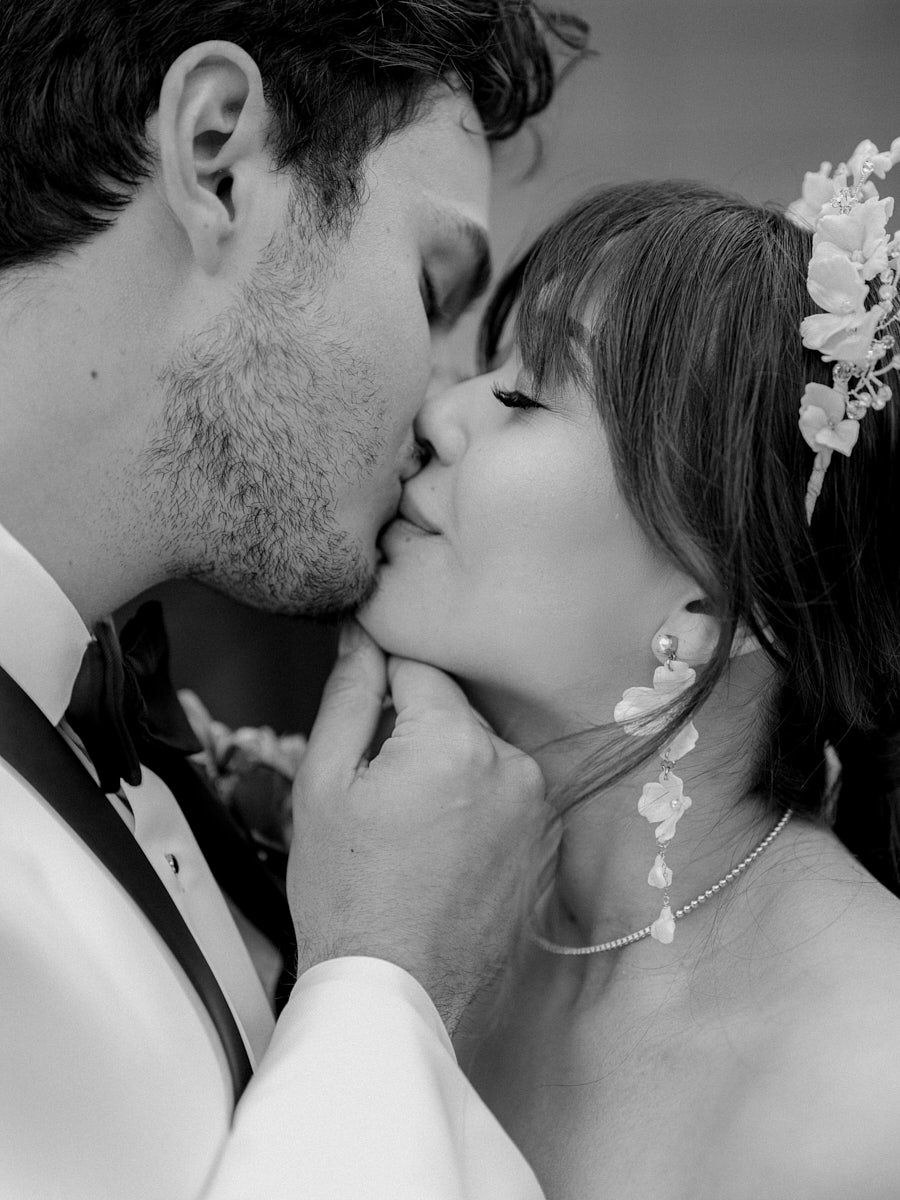 Intimate close-up of bride and groom kissing, capturing romantic Riga wedding moments