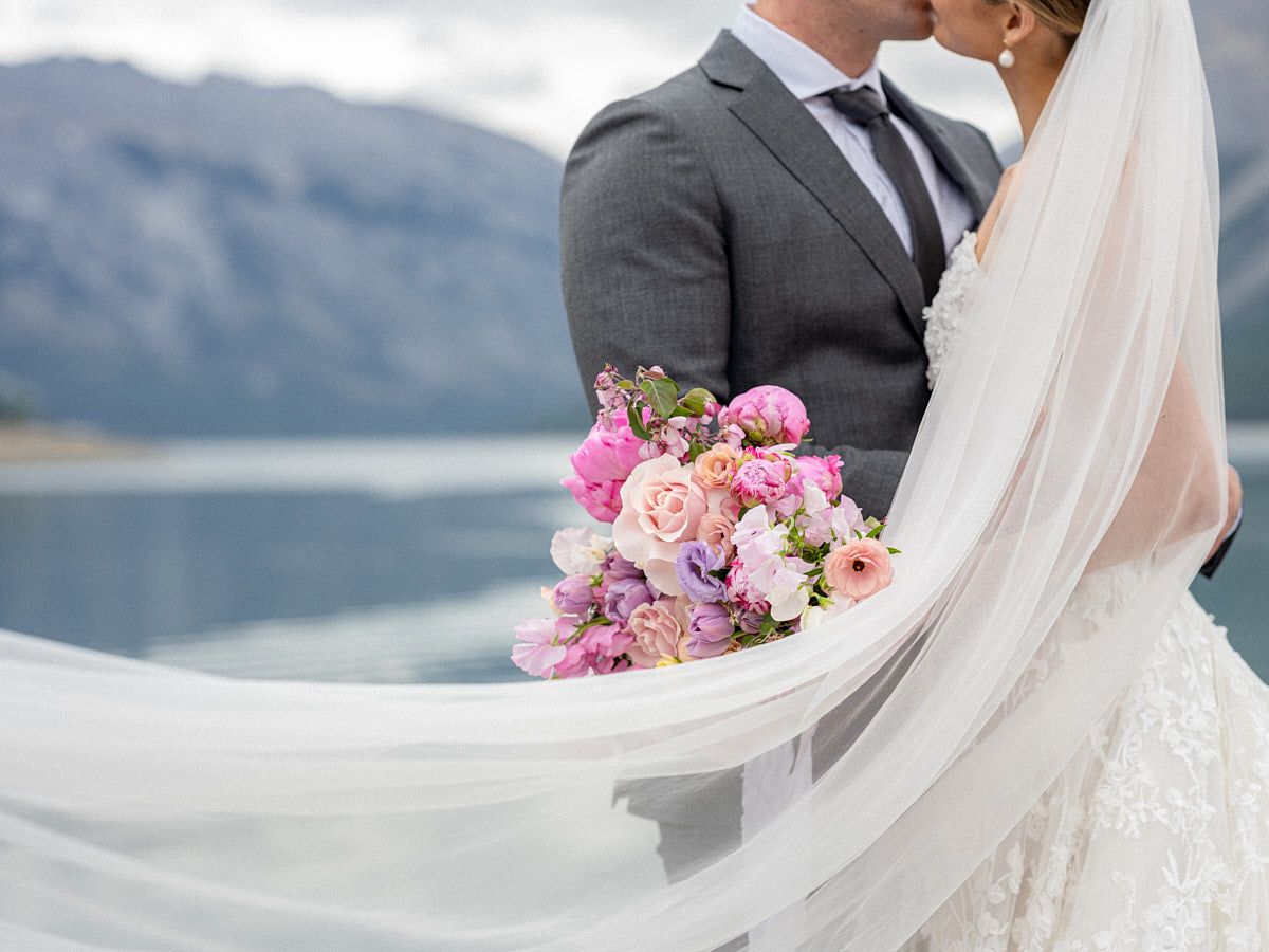 Bride and groom portrait highlighting delicate veil and bridal bouquet, ideal for Riga weddings