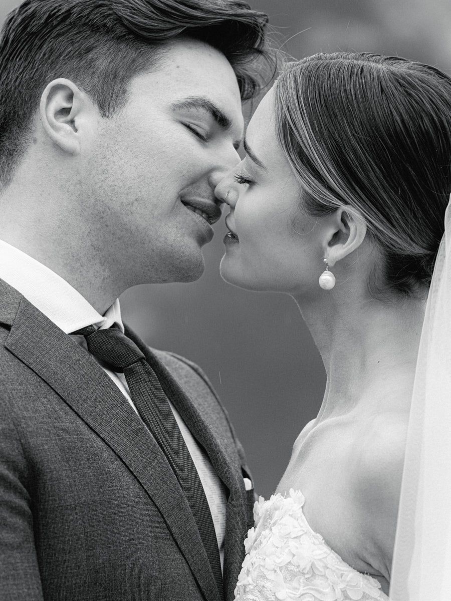 Intimate close-up of bride and groom kissing, capturing romantic Riga wedding moments