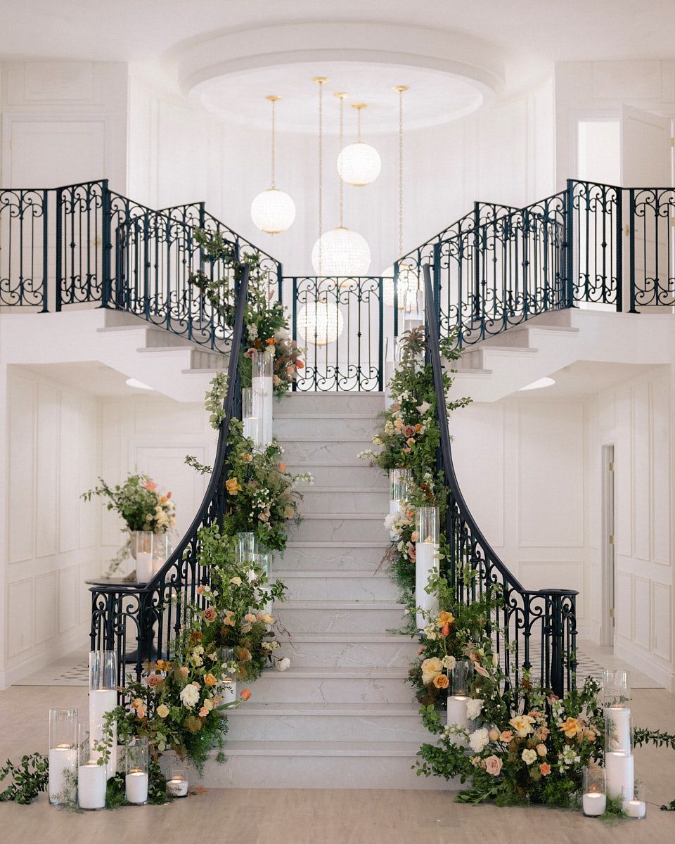 Elegant grand staircase adorned with flowers, styled for a Riga wedding ceremony