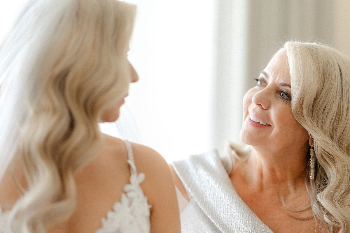 Bride sharing heartfelt pre-wedding moment with her mom, perfect for Riga wedding photography