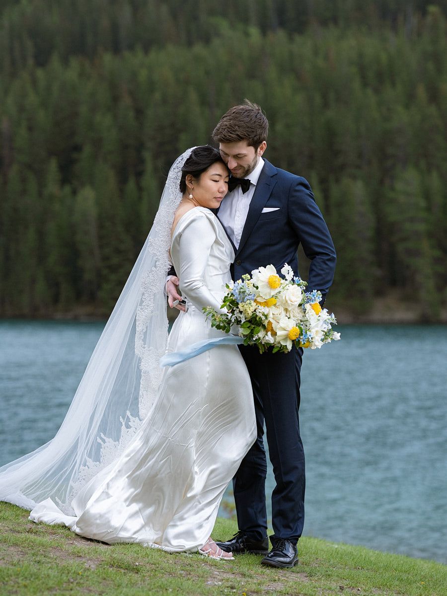 Baltic-inspired wedding portrait of couple near a picturesque forested lake
