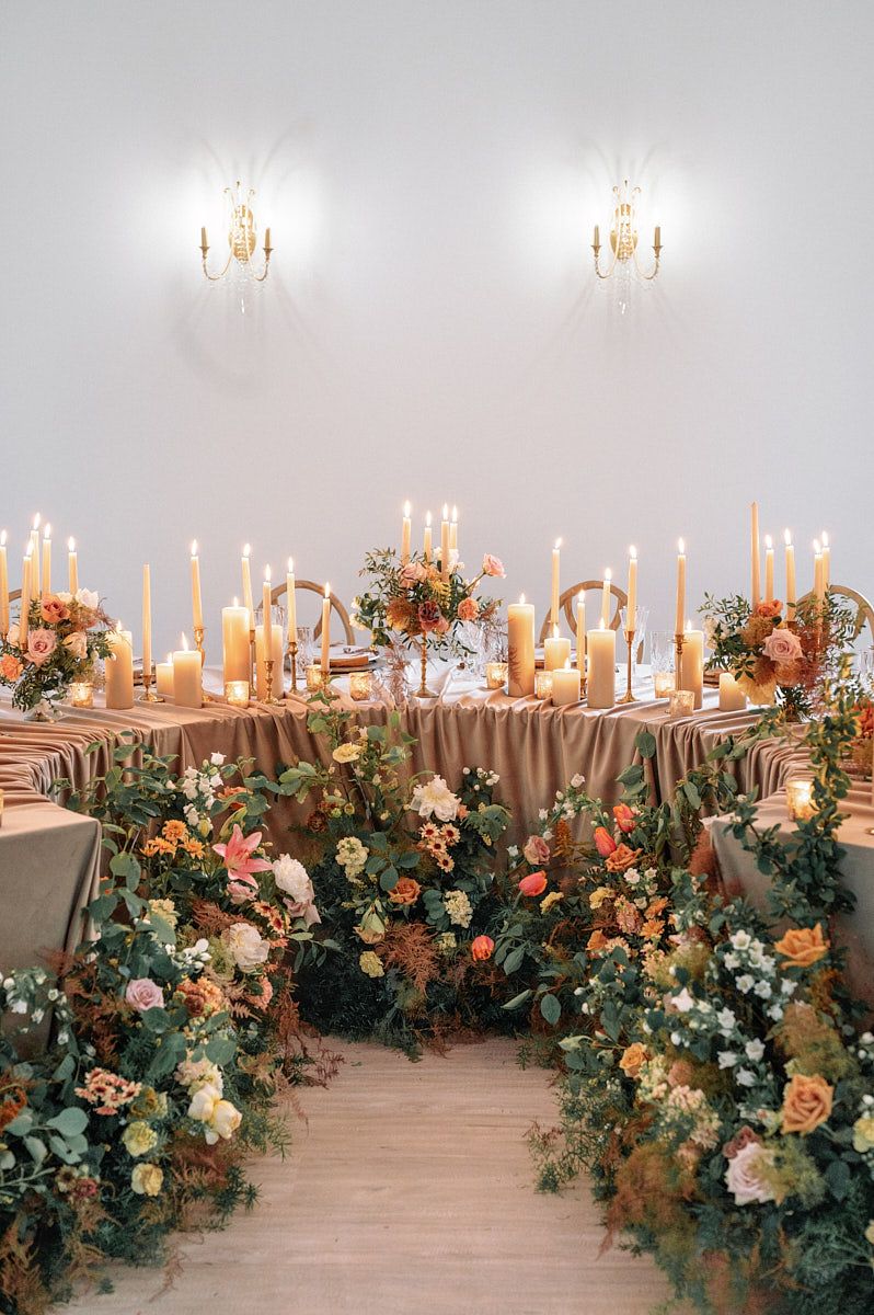 Curved wedding reception table setup in Riga, styled with elegant decor and floral accents