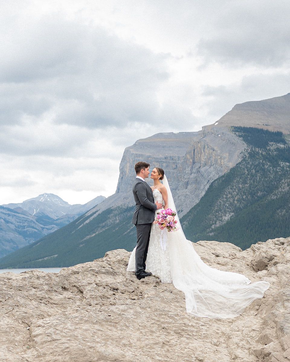 Stunning European mountain lake backdrop for bride and groom wedding portraits