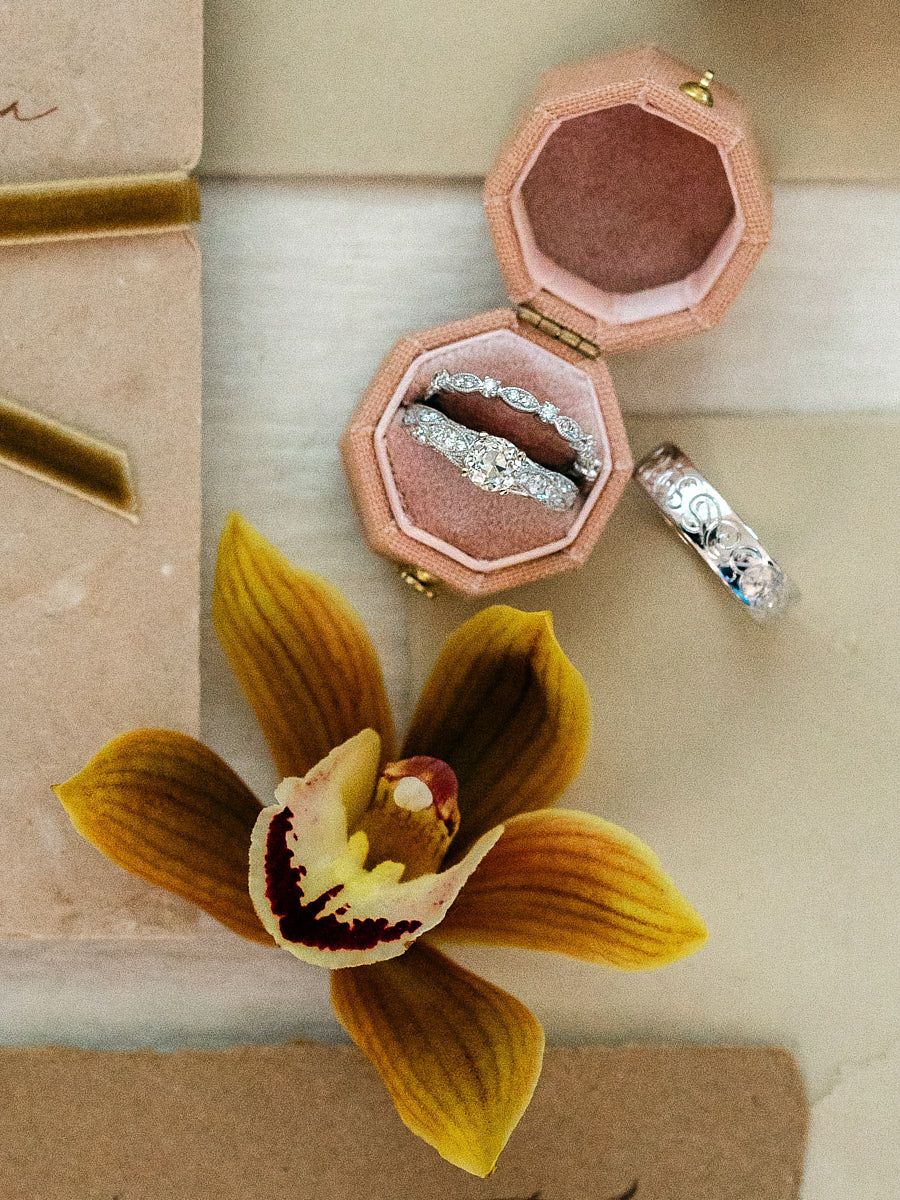 Romantic vintage wedding flatlay featuring rings and delicate details, elegant Riga wedding styling