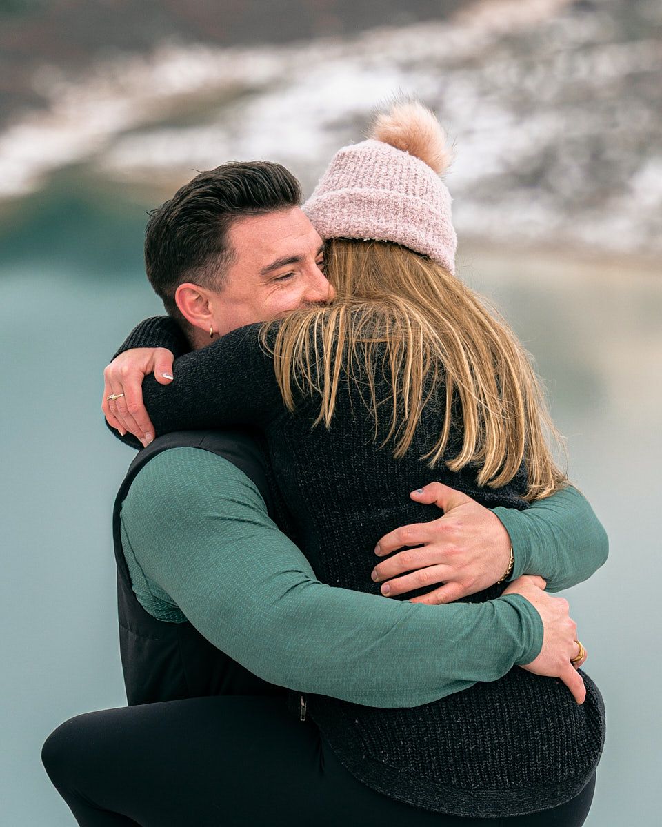 Proposal with “Will you marry me” scroll in scenic mountain engagement session in Europe