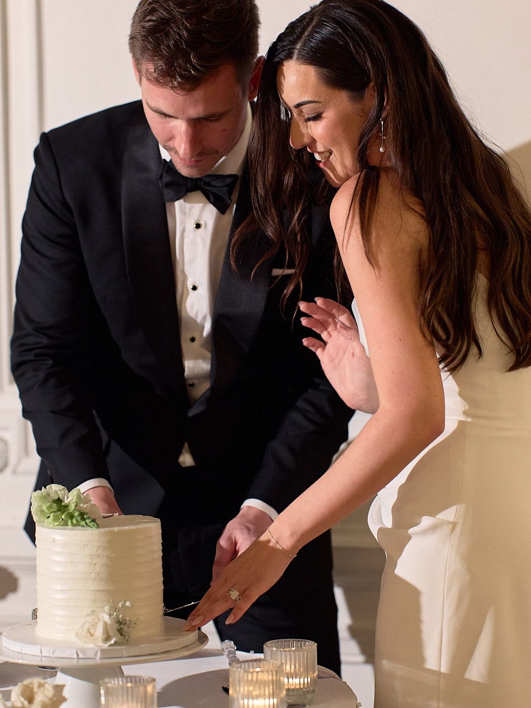 Bride and groom cutting their wedding cake in Riga