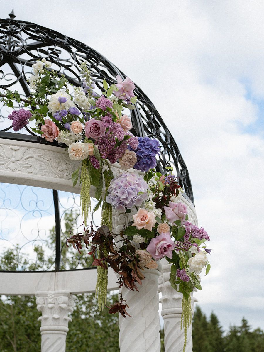 Wedding ceremony gazebo adorned with elegant floral decorations, ideal for Riga outdoor weddings