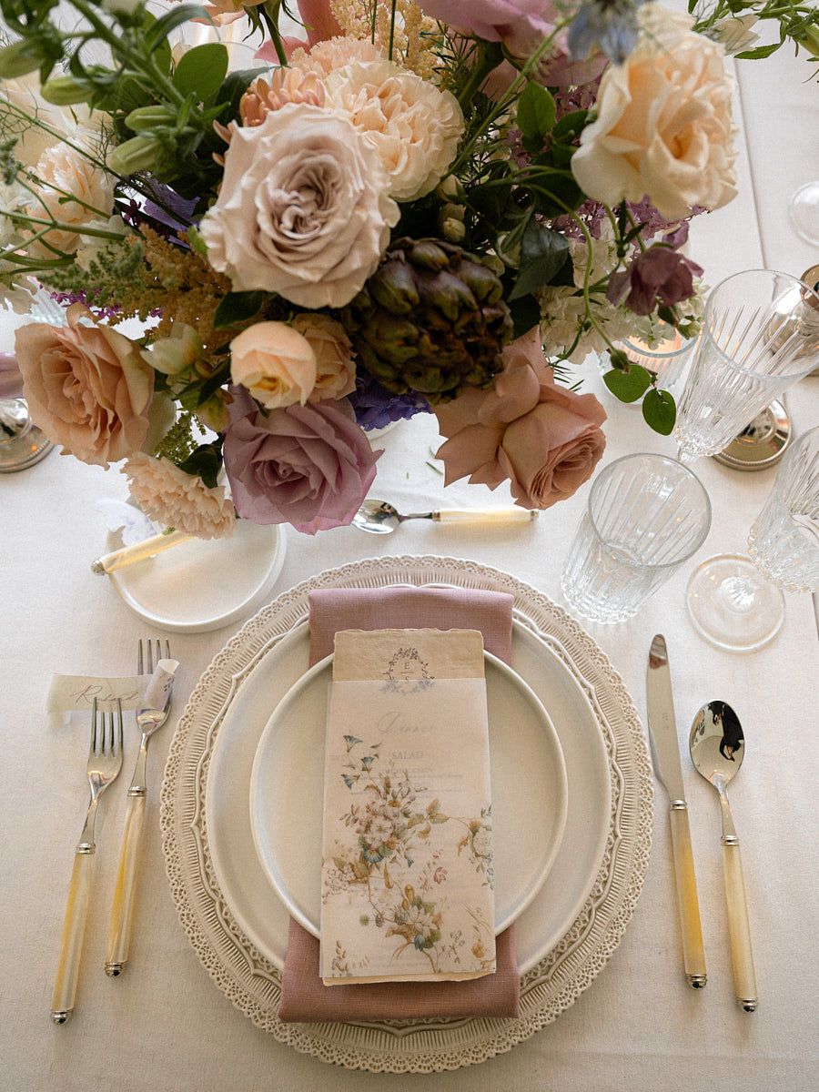 Elegant pastel wedding table setting with florals, plates, and glassware, perfect for Riga weddings