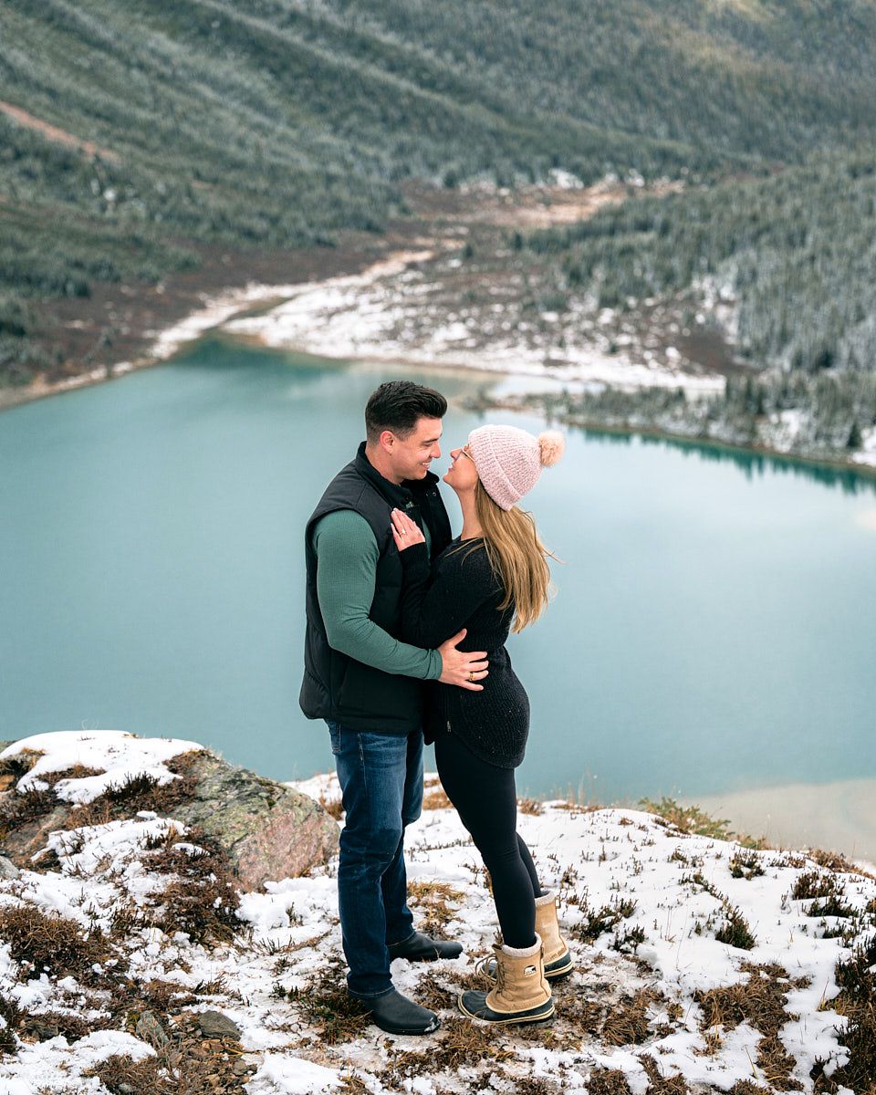 Proposal with “Will you marry me” scroll in scenic mountain engagement session in Europe
