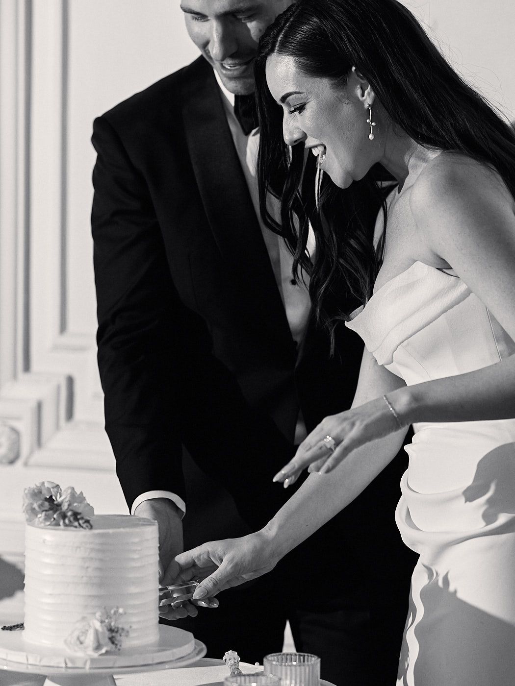 Bride and groom cutting their wedding cake in Riga