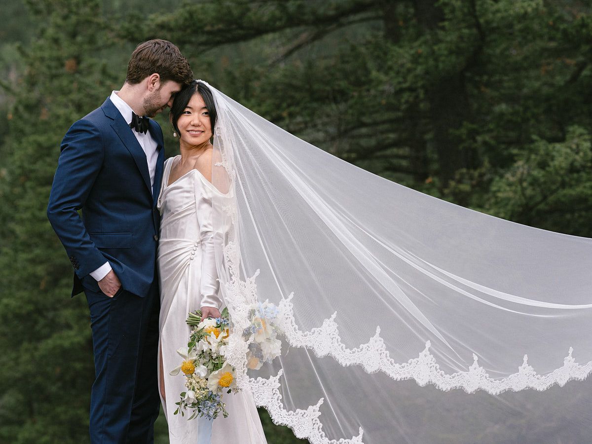 Romantic bride and groom portrait in front of a forest castle, perfect for Riga wedding inspiration
