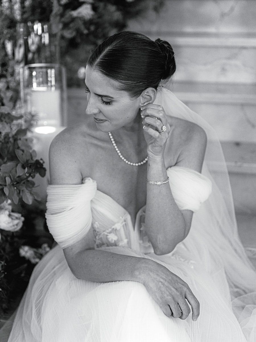 Graceful bride on grand staircase, timeless Riga wedding portrait with dramatic lighting