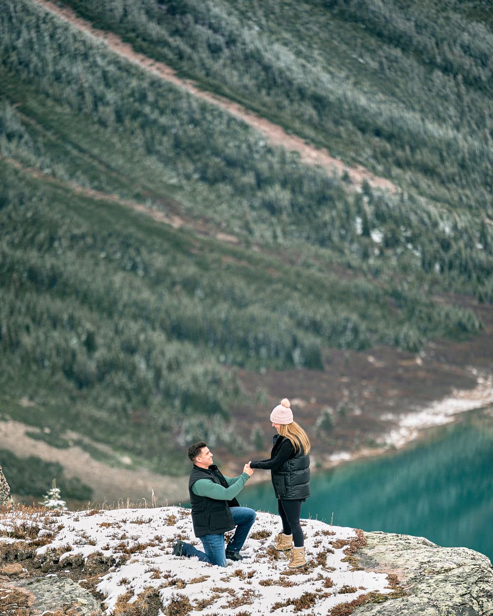 Man proposing to fiancée atop scenic Canadian mountains