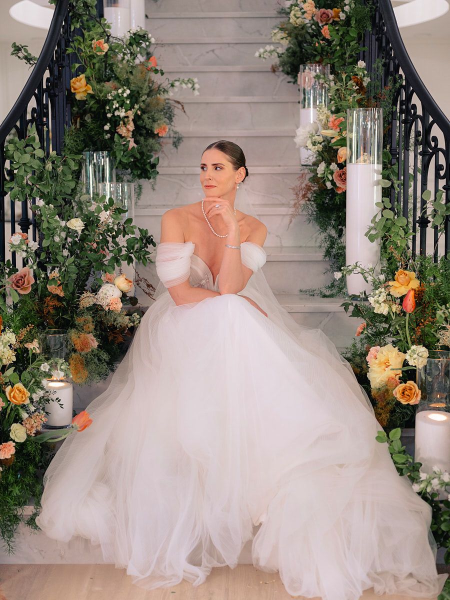 Romantic bridal portrait on grand staircase, capturing Riga wedding elegance