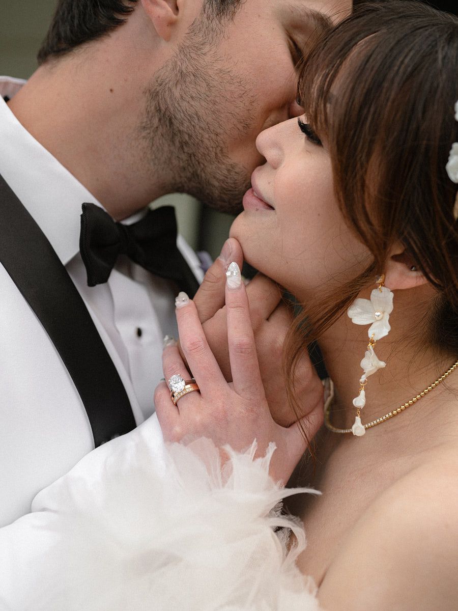 Groom whispering to bride, capturing playful and intimate Riga wedding moment