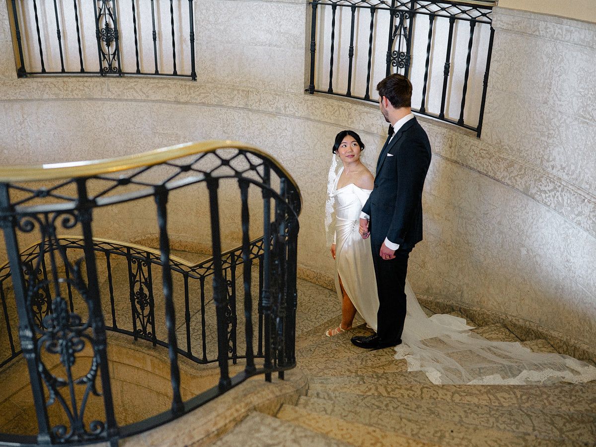 Bride and groom sharing a moment in a grand castle hall, ideal for European wedding inspiration