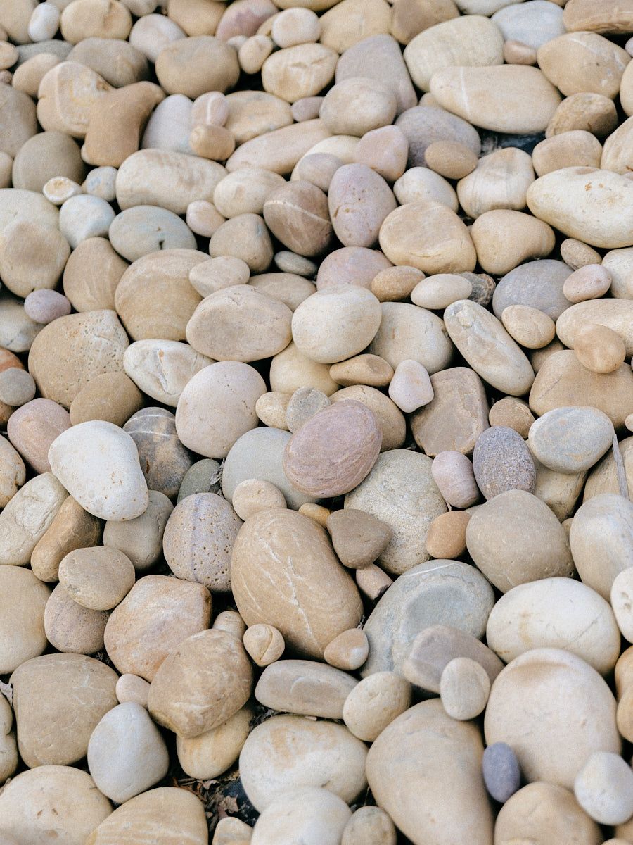 Decorative pebbles by a Riga wedding fountain, detail shot highlighting venue styling and outdoor decor