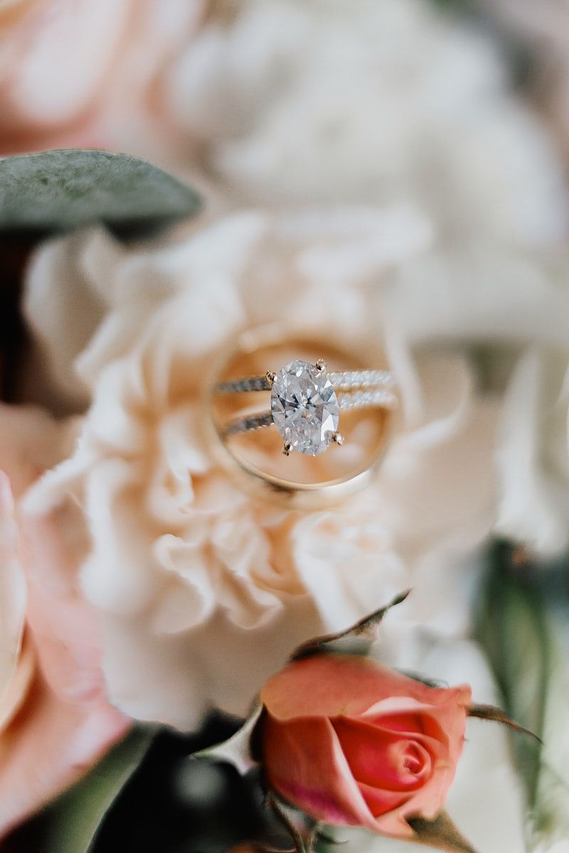 Diamond engagement ring nestled in bridal bouquet, Riga wedding detail