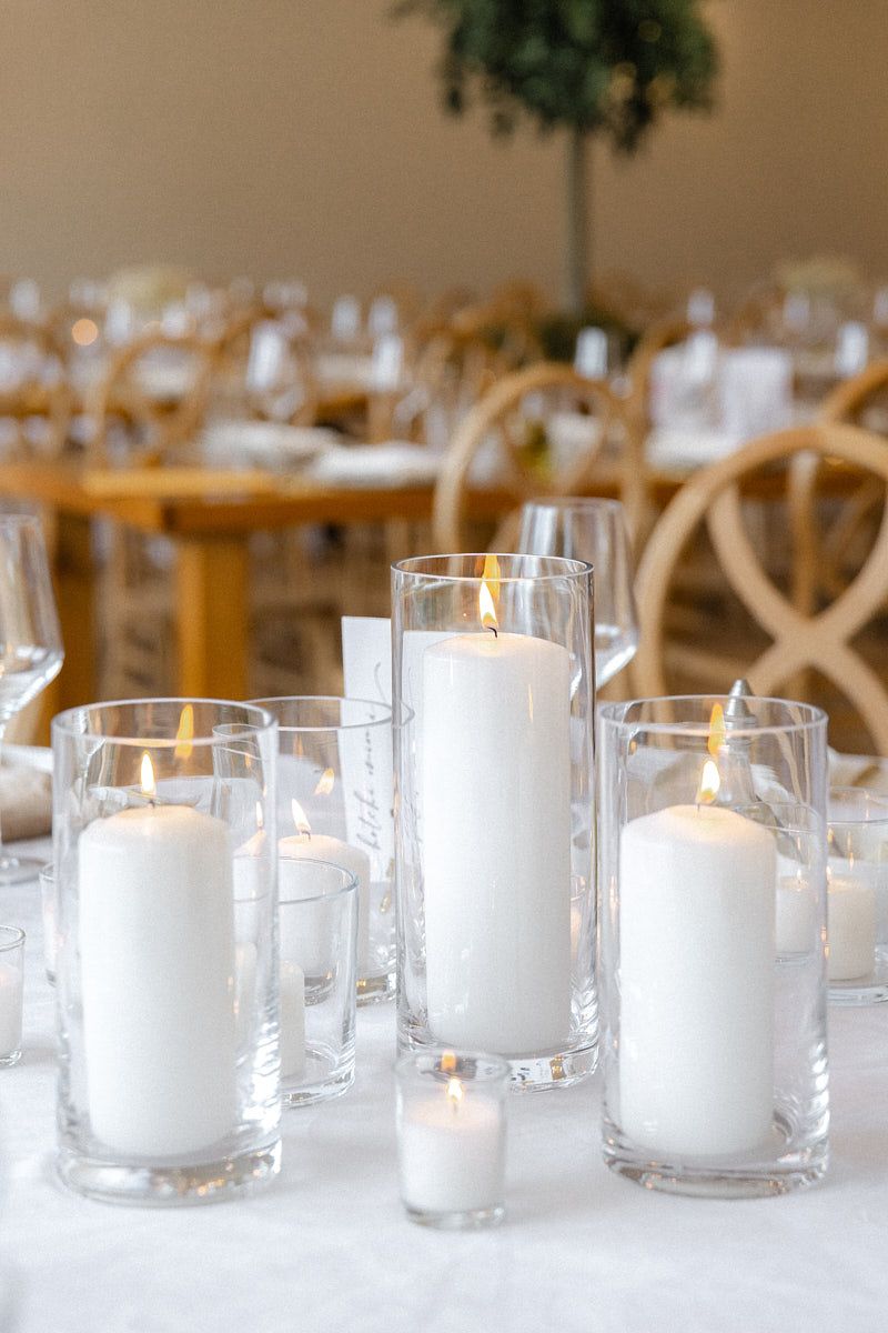 Elegant white candles enhancing wedding table decor, creating romantic Riga reception ambiance