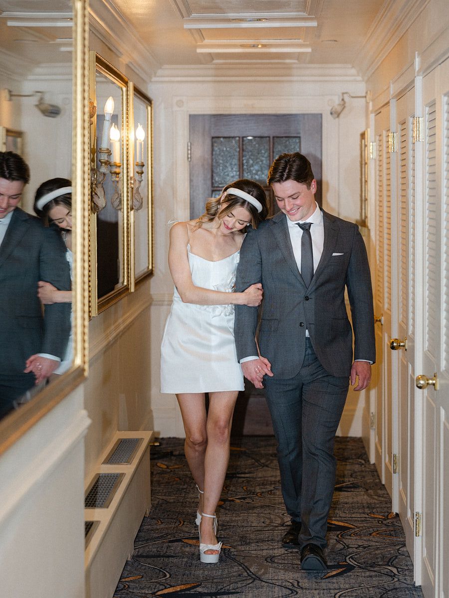 Bride and groom walking to Fairmont Hotel wedding reception in Riga