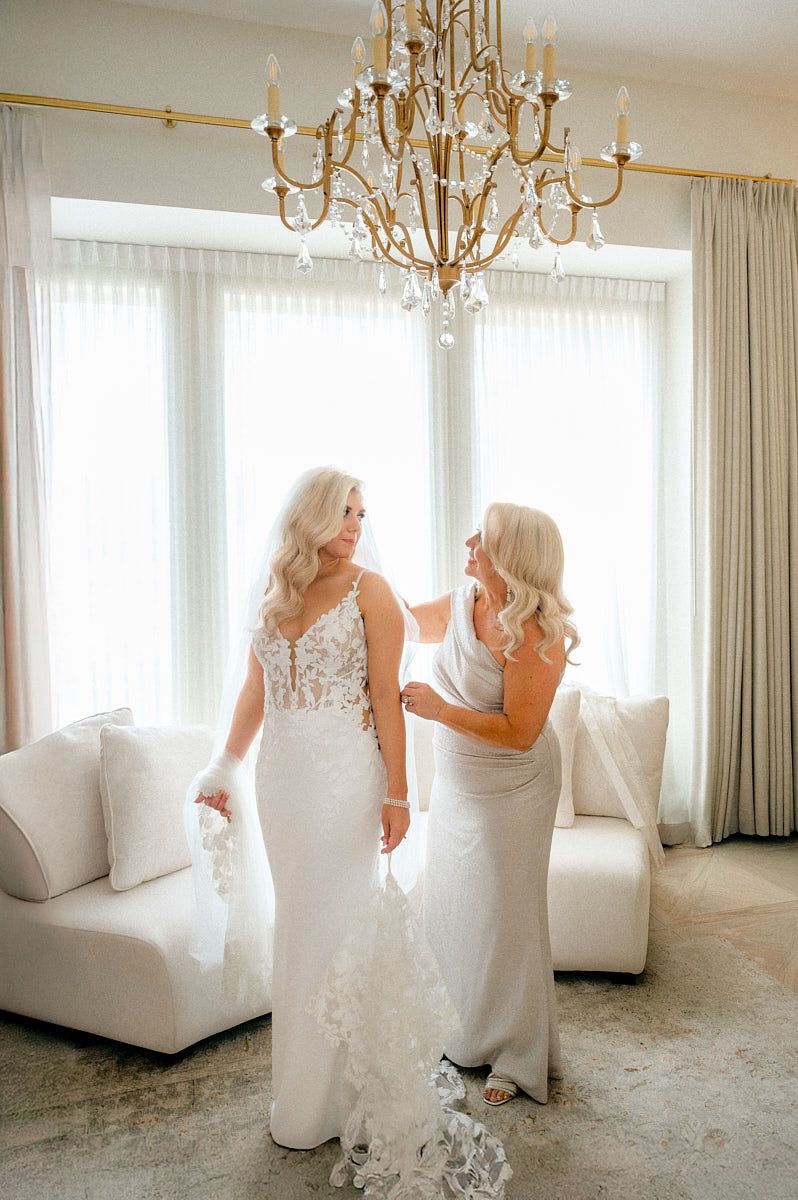 Emotional moment between bride and mother while getting ready, capturing intimate Riga wedding memories